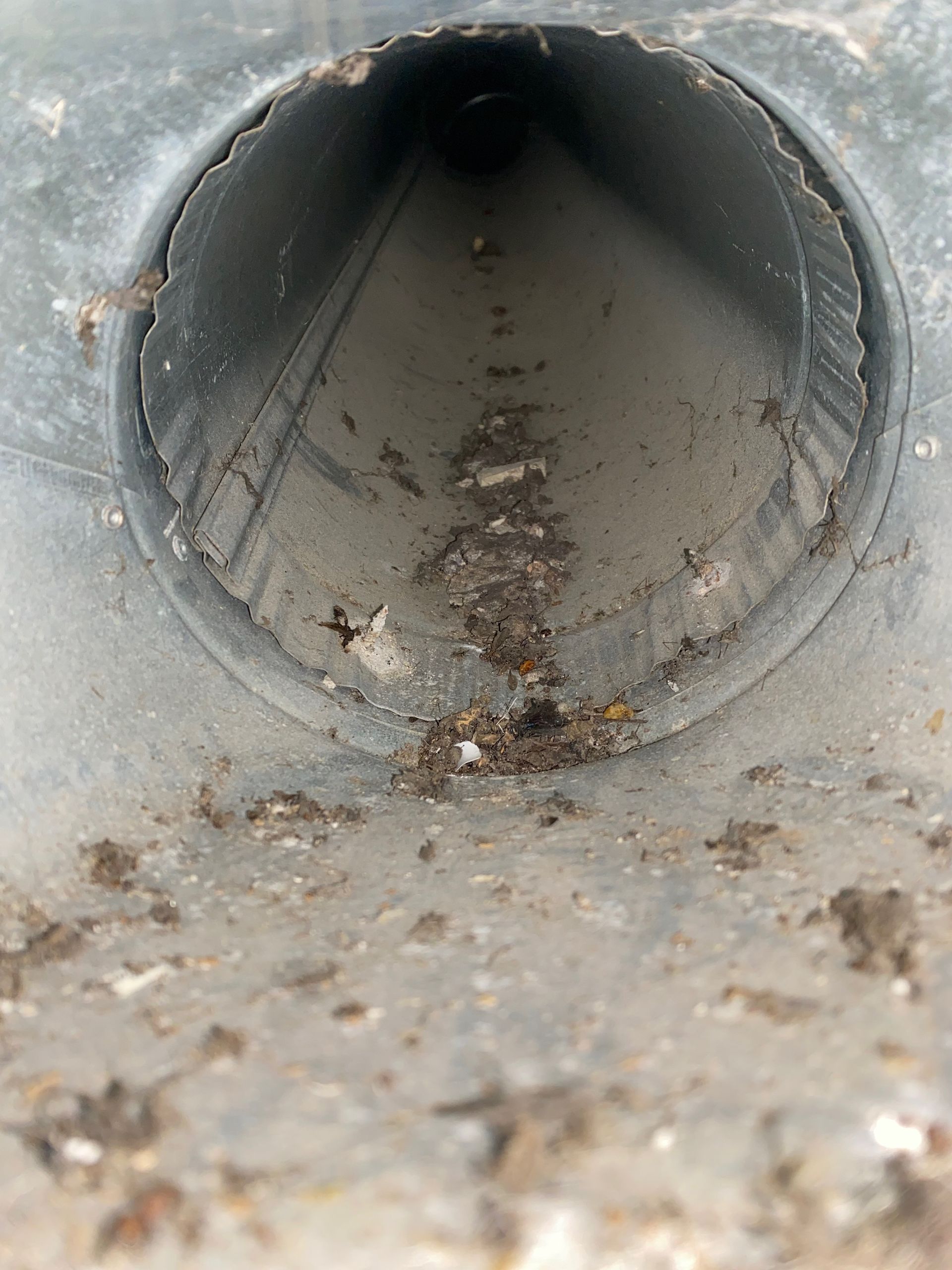 A close up of a metal pipe with a hole in the middle