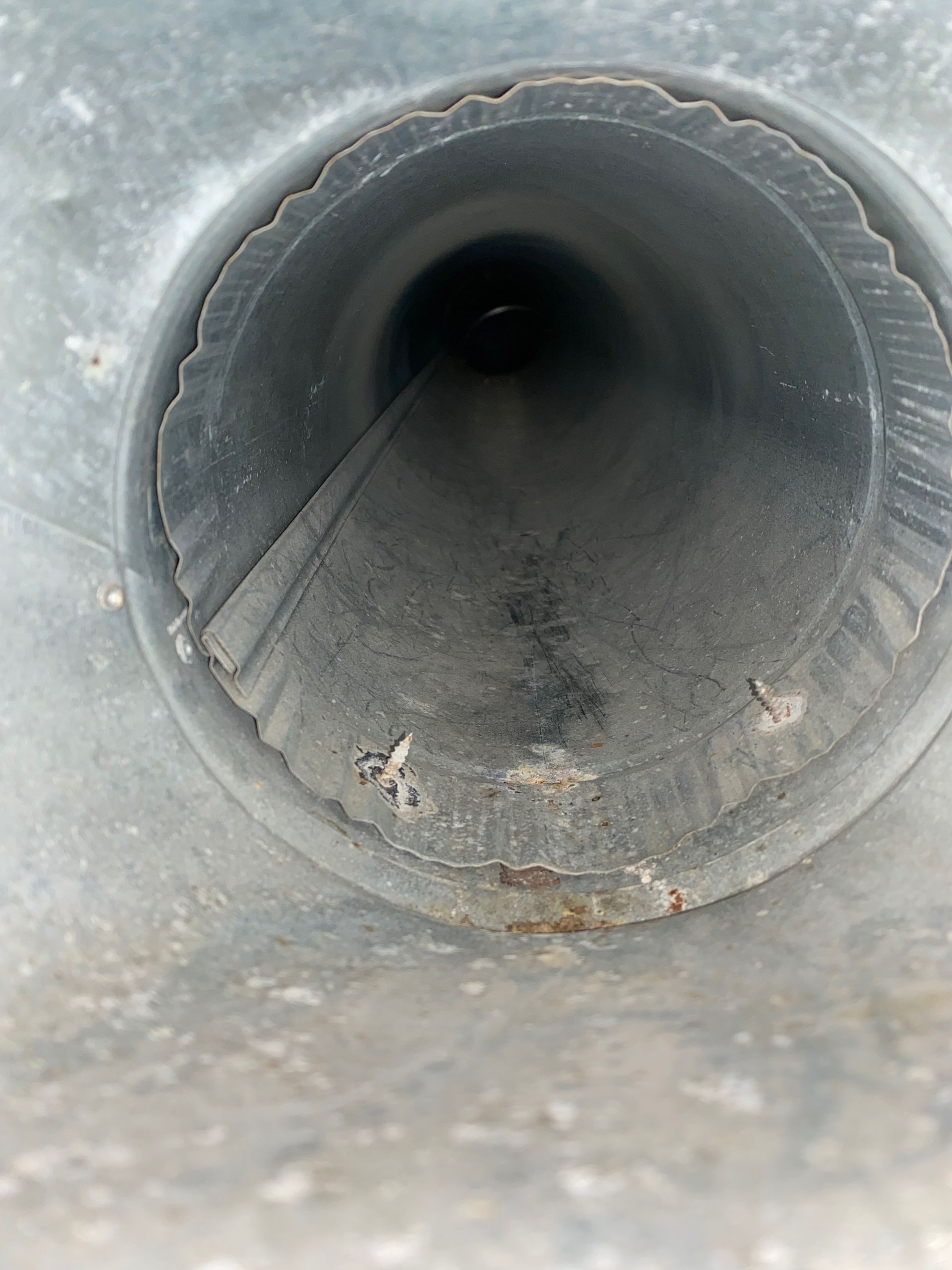 A close up of a metal pipe with a hole in the middle