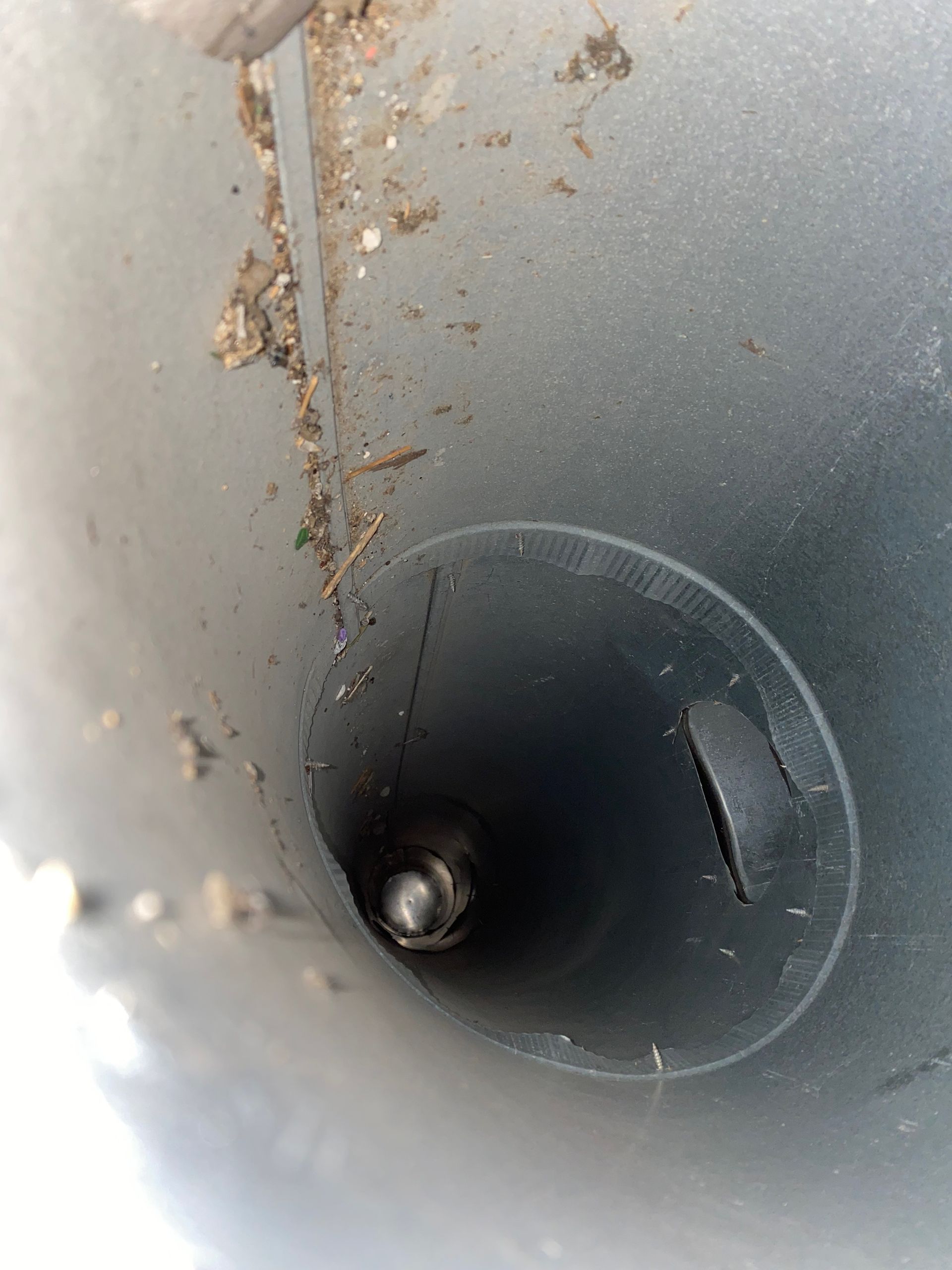 A close up of a metal pipe with a hole in the middle