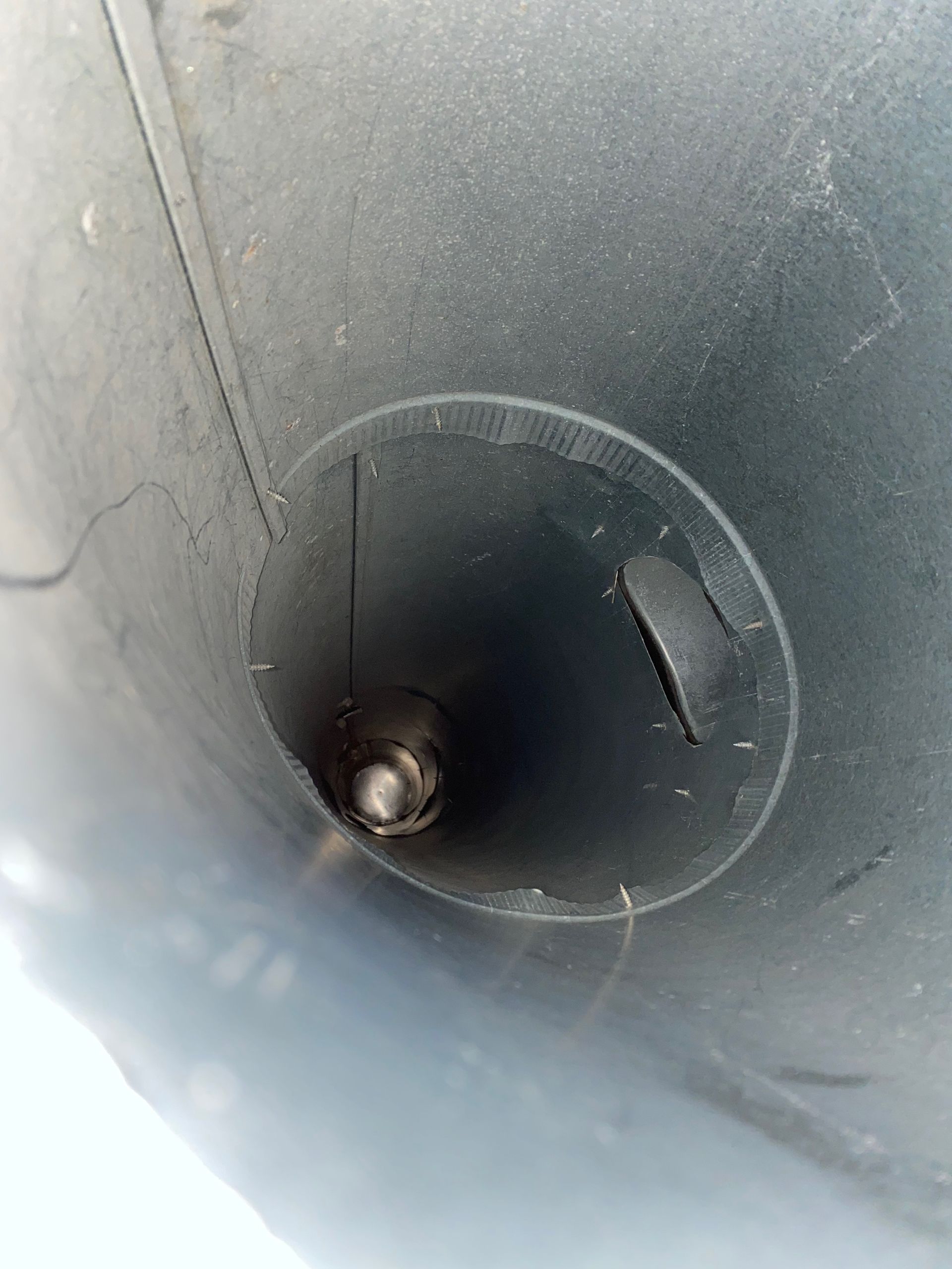 A close up of a metal pipe with a hole in the middle