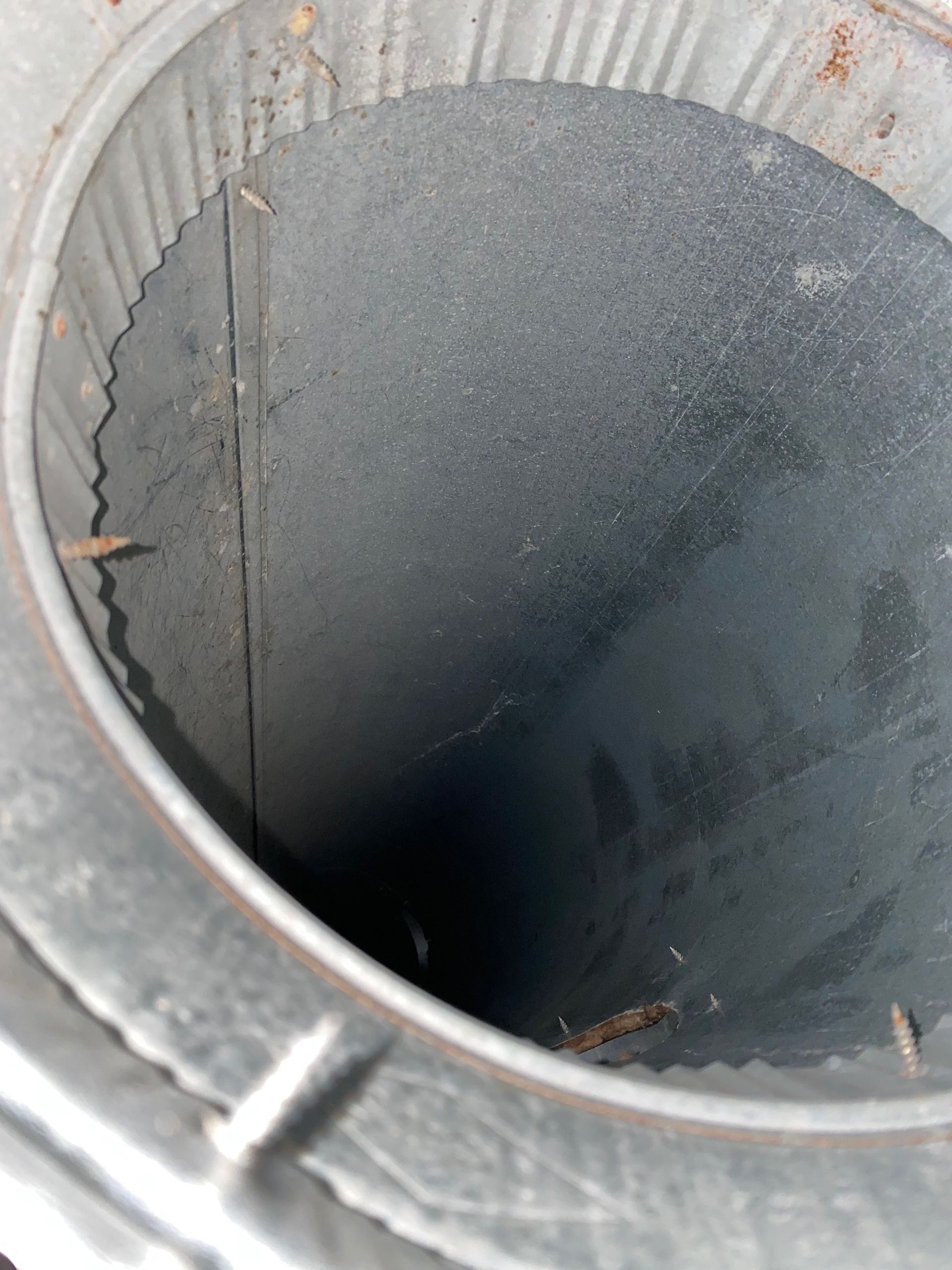 The inside of a metal container with a hole in the middle