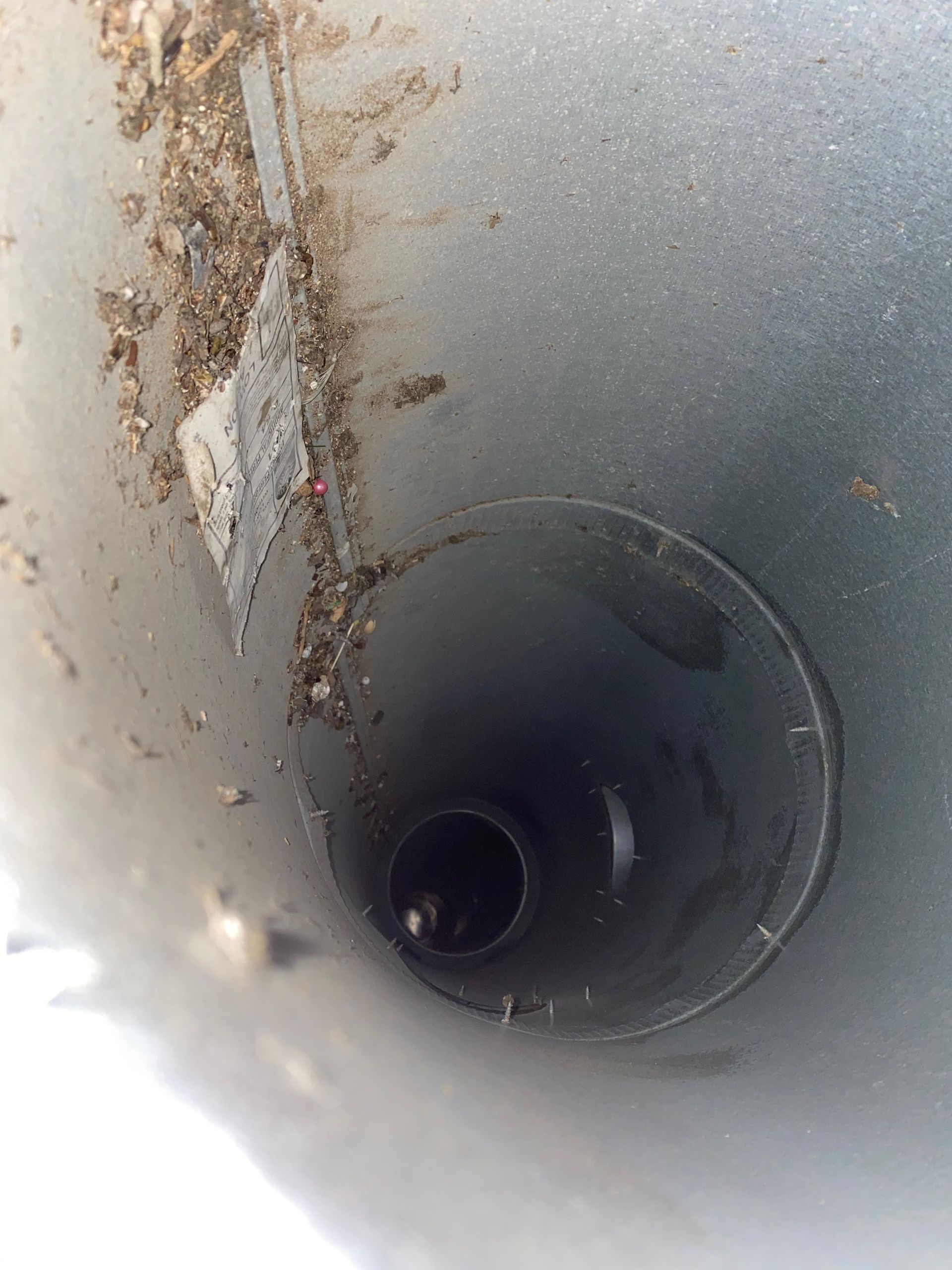A close up of a hole in a metal pipe