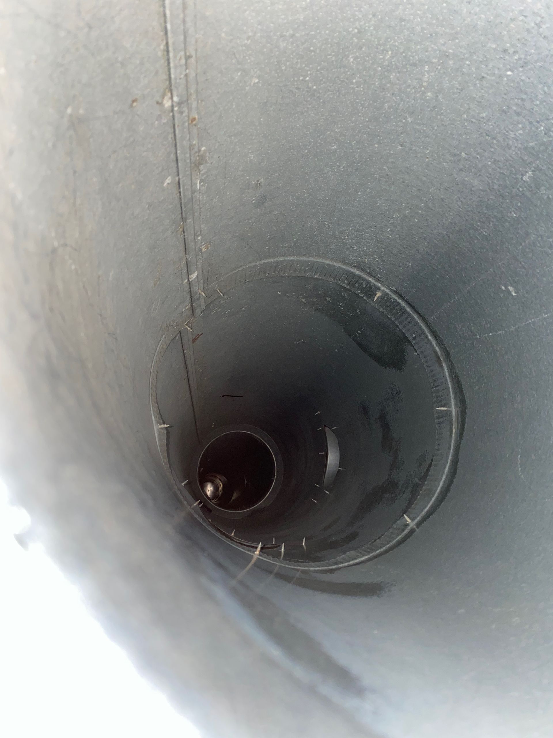 A close up of a metal pipe with a hole in the middle