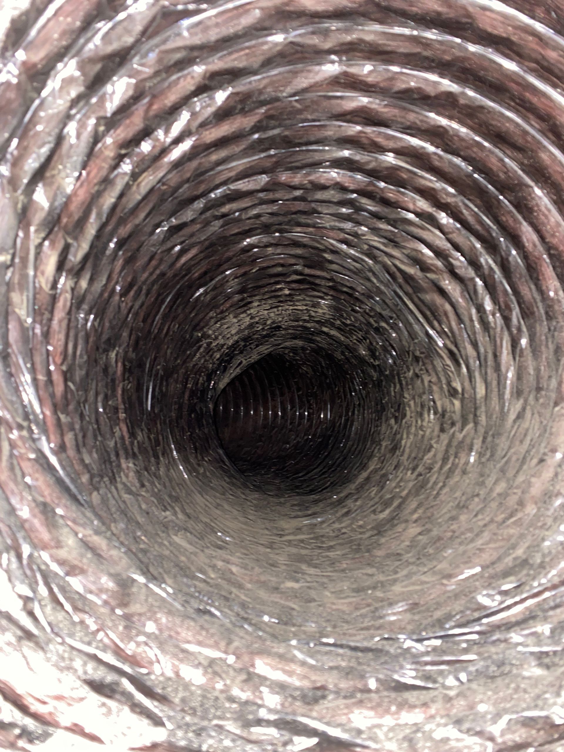 A close up of the inside of a duct with a hole in the middle.