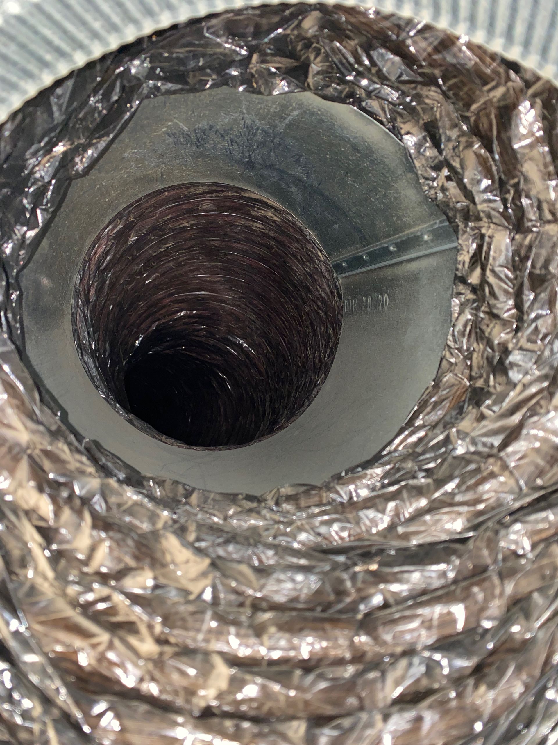 A close up of a duct with a hole in it