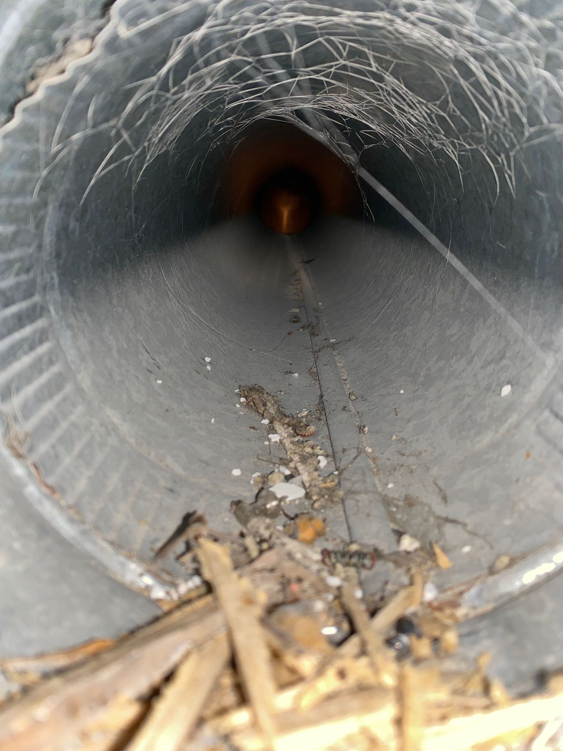 A close up of a metal pipe with a hole in it