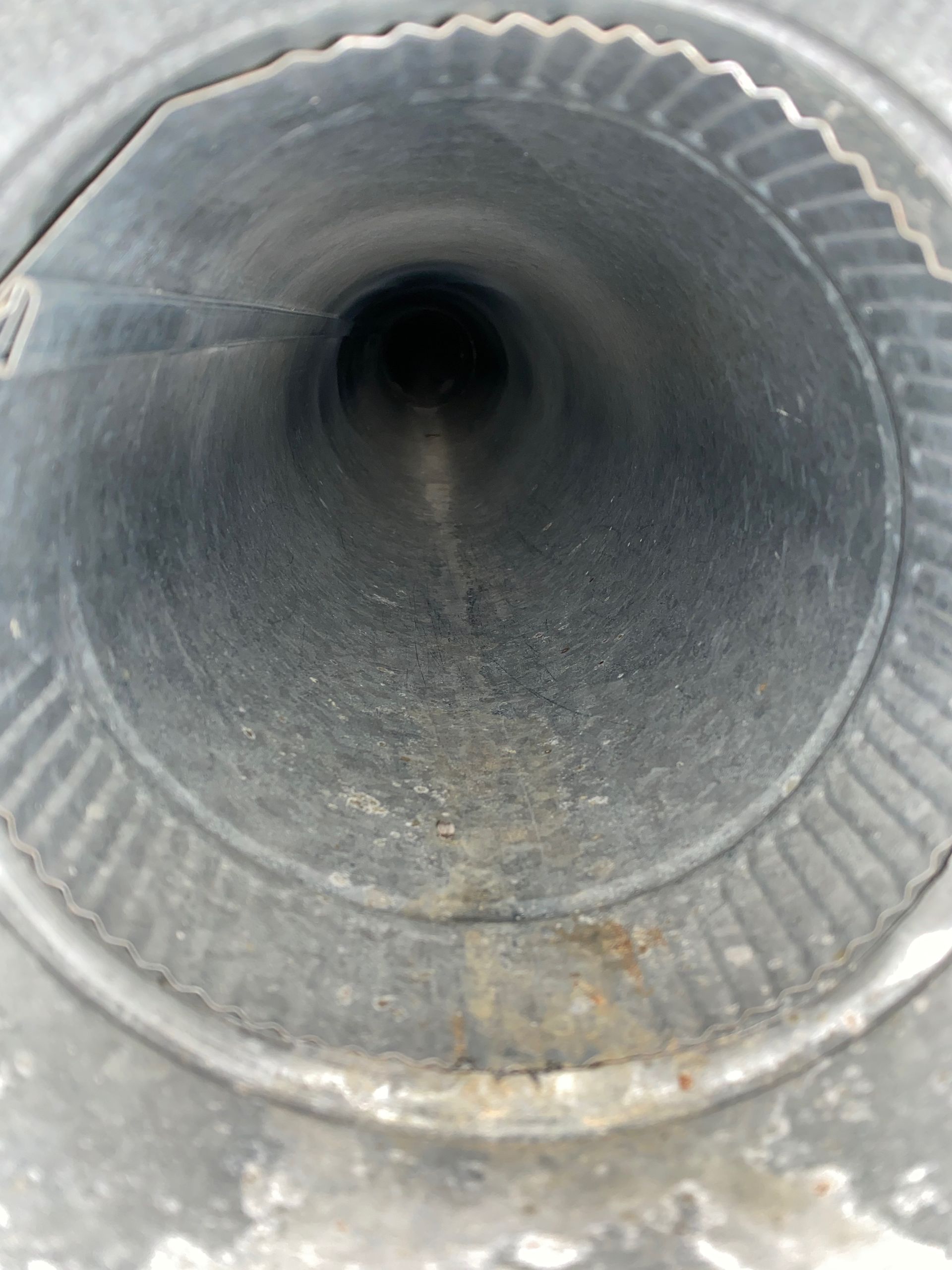 A close up of a metal pipe with a hole in the middle
