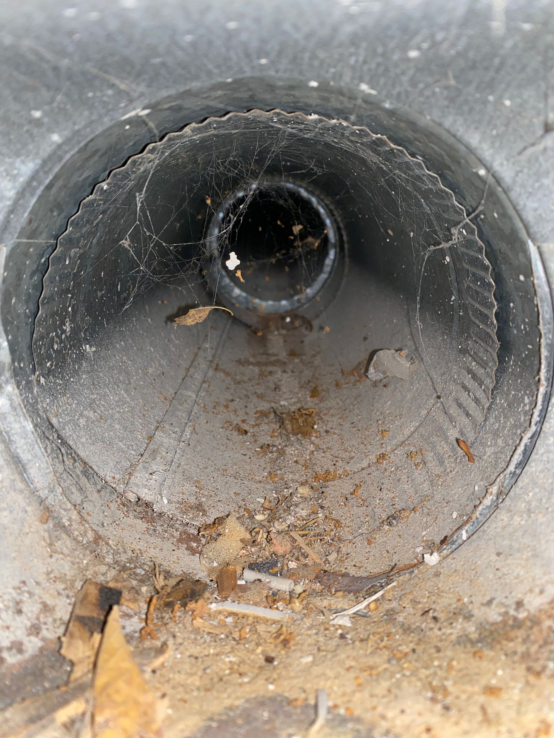 A black pipe with a hole in the middle of it