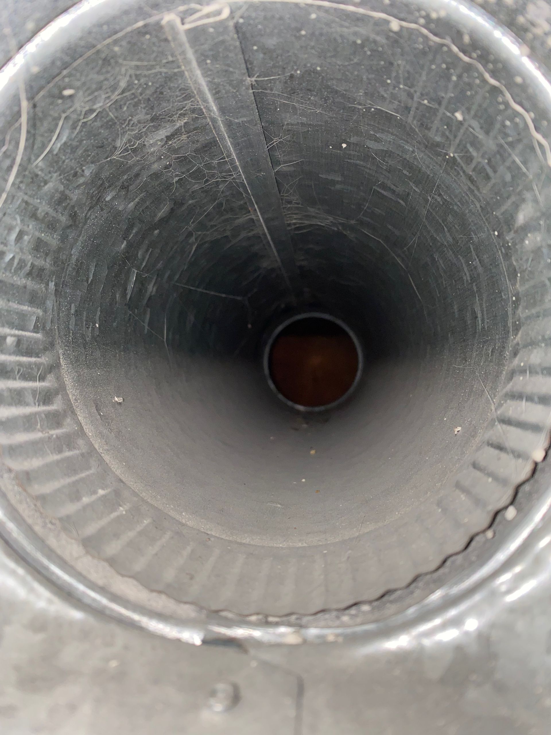 A close up of a metal pipe with a hole in the middle
