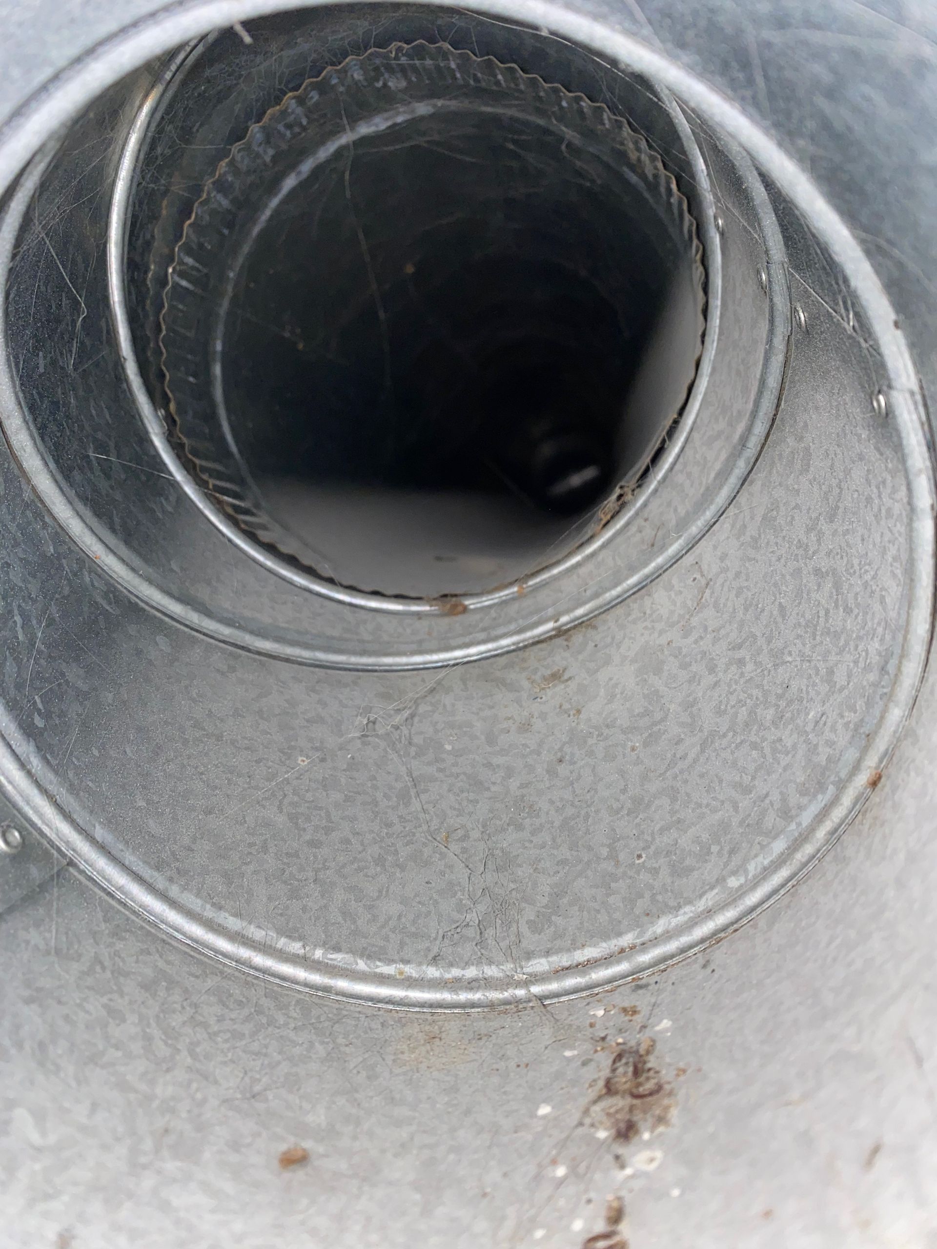 A close up of a metal pipe with a hole in the middle.