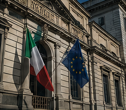 Bandiere italiane e dell'UE sventolano sulla facciata di un edificio storico.