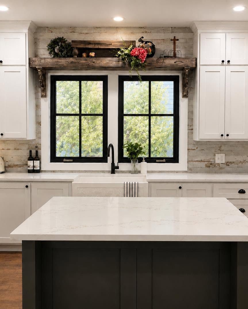 Bright modern kitchen with white cabinets, marble island, black windows, and rustic wood shelf above sink