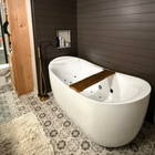 Modern bathroom with a freestanding white tub and patterned tile floor