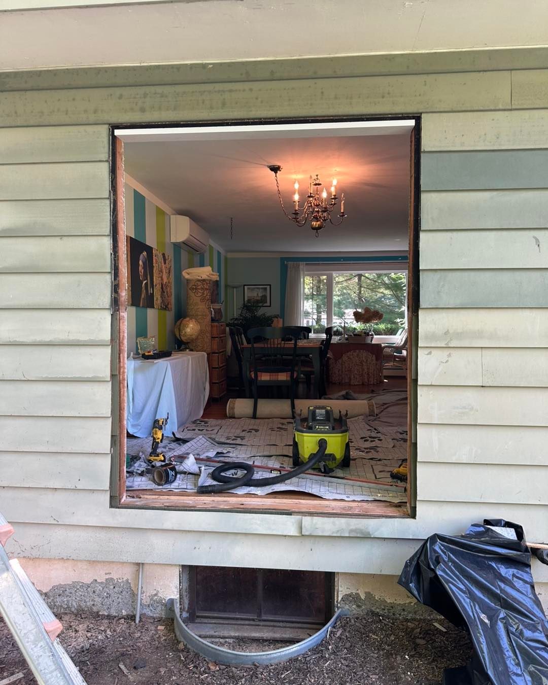 Opening in exterior wall, looking inside a home. Window installation in progress.