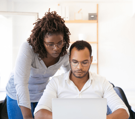 manager and employee at computer having discussion