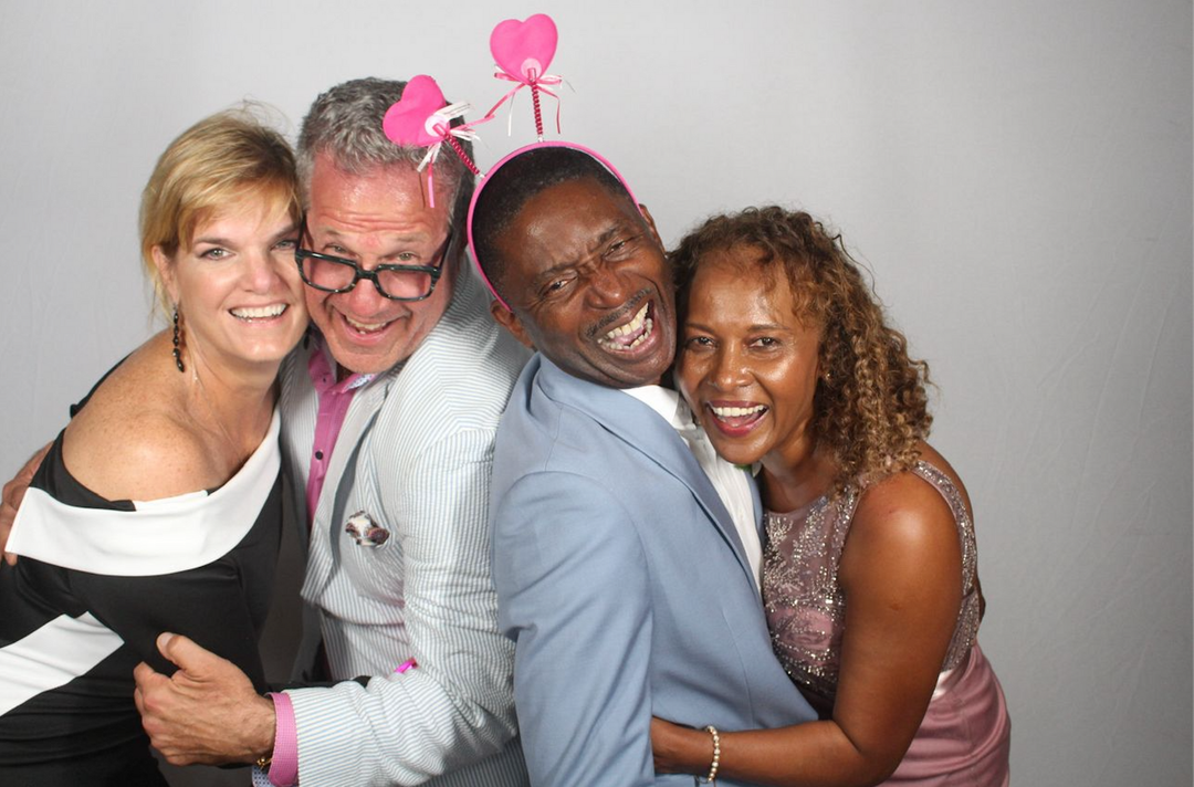A group of people are posing for a picture in a photo booth.