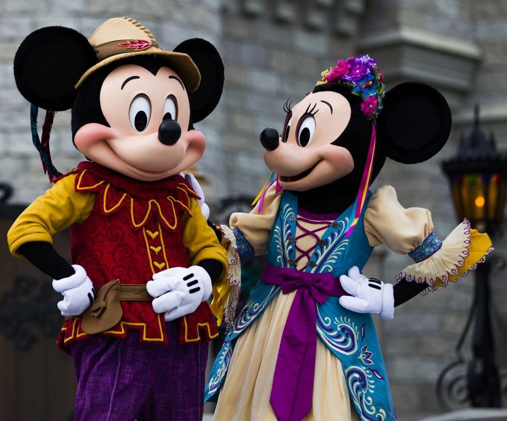 Mickey mouse and minnie mouse are standing next to each other
