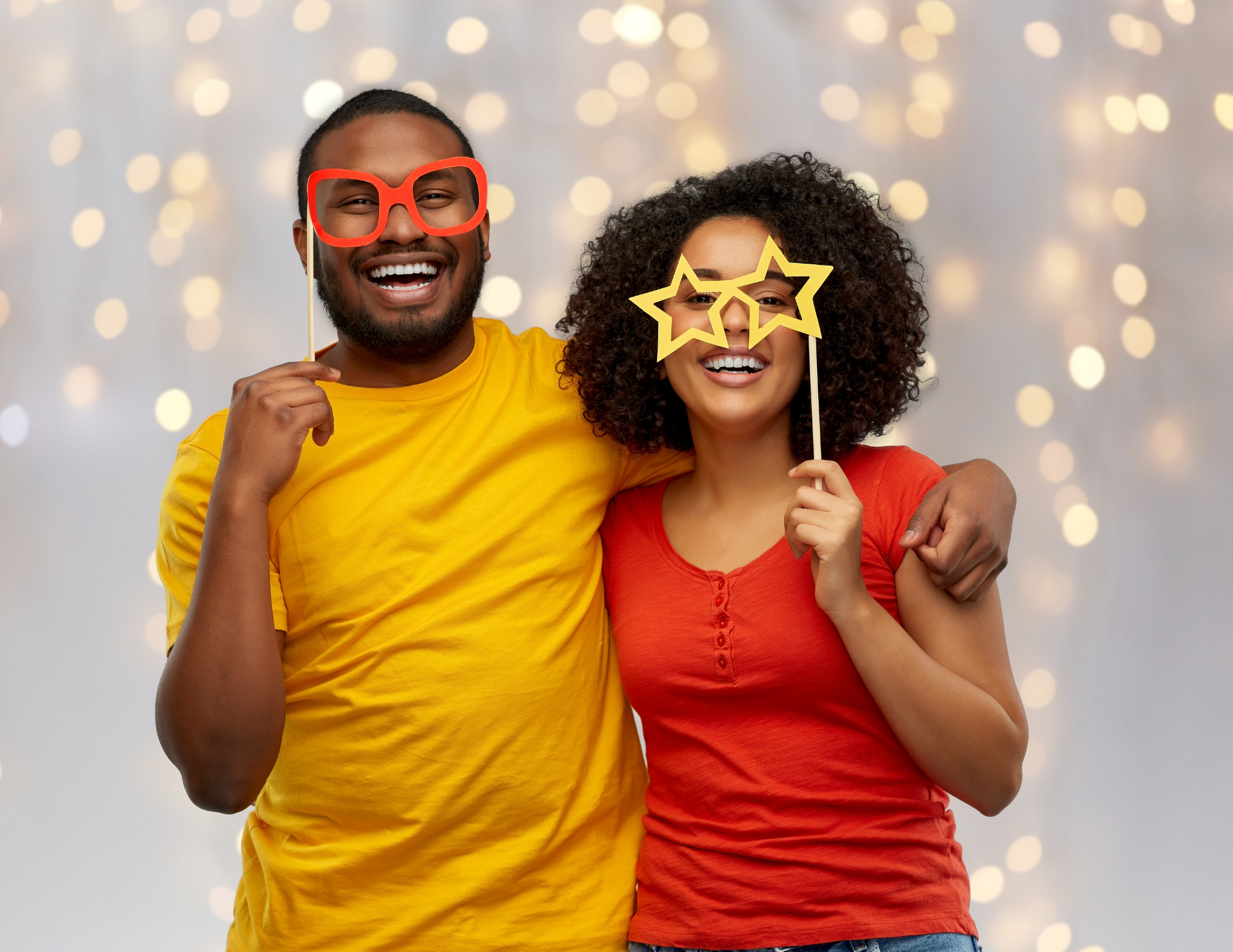 A man and a woman are posing for a picture while wearing star glasses.