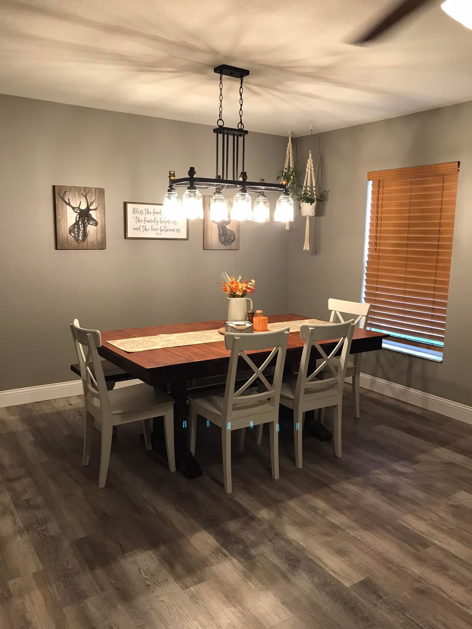 a dining room with a table and chairs and a chandelier .
