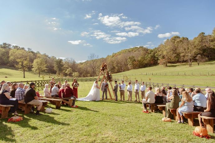 A large family is posing for a picture on the porch of their house.
