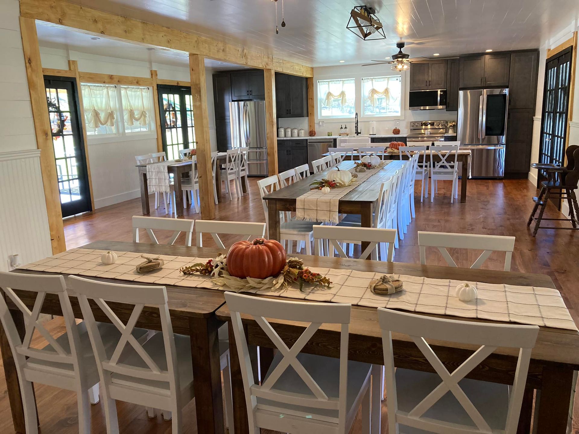 There is a long table with a pumpkin on it in the middle of the room.