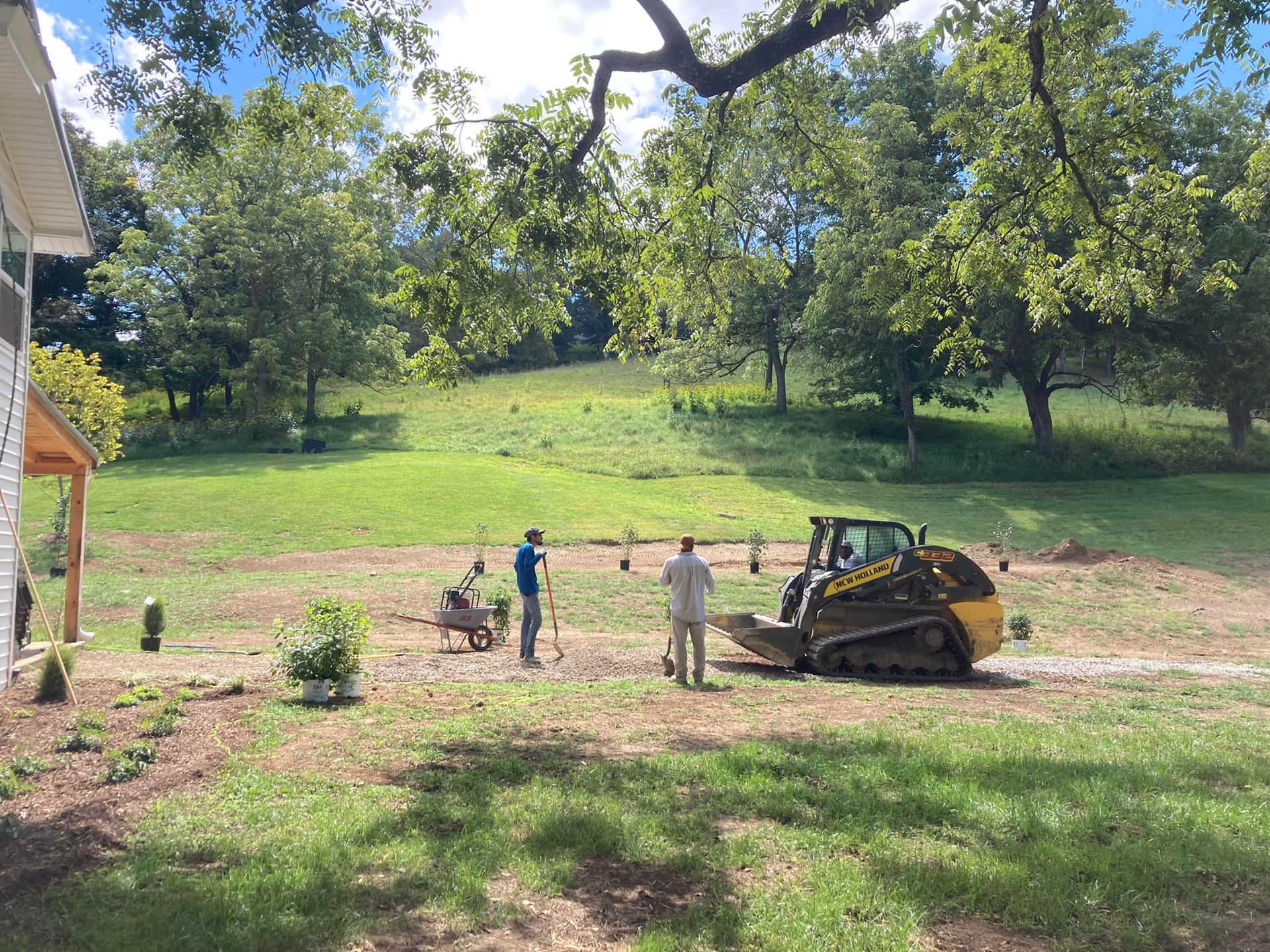 A man is standing next to a bulldozer in a field.