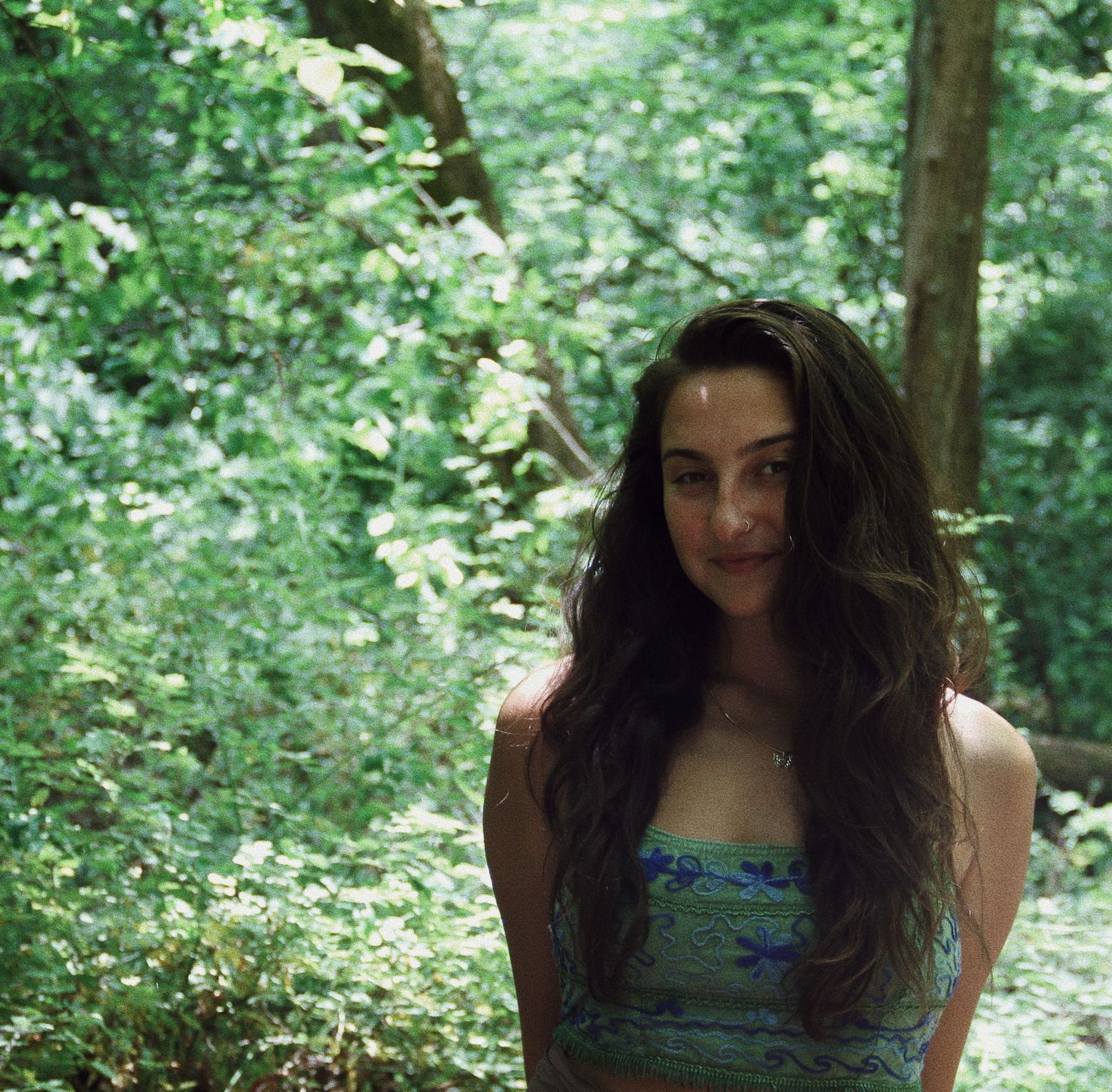 Madi Eunis Yoga Instructor/coach face shot in green nature