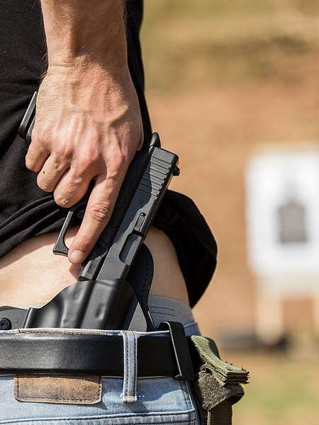 Person With A Gun On Pocket