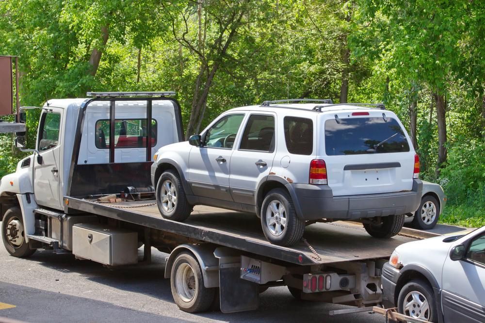 Two Cars Are Being Towed by A Tow Truck — Lismore Car Repairs in Lismore, NSW