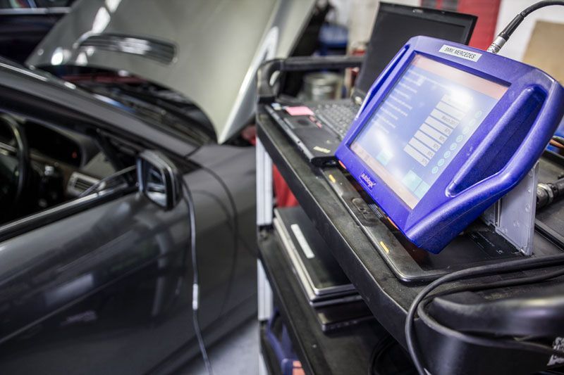 A Car with The Hood up Is Sitting Next to A Computer on A Cart — Lismore Car Repairs in Lismore, NSW