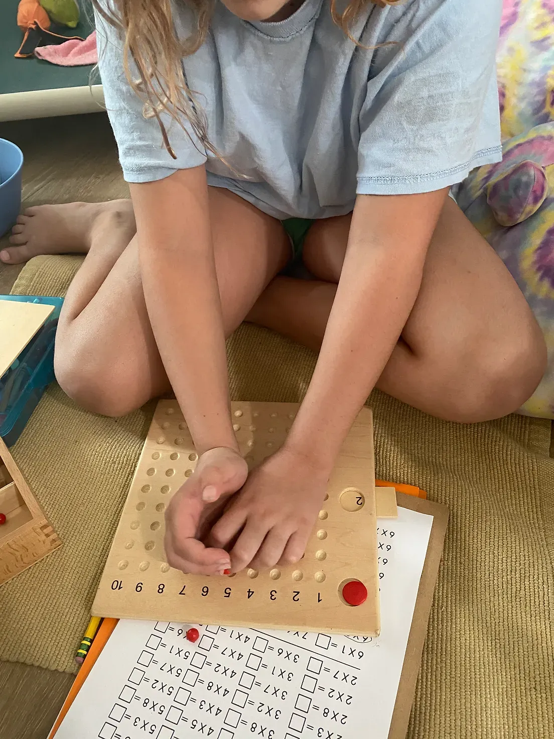 A young girl is sitting on the floor playing with a toy.