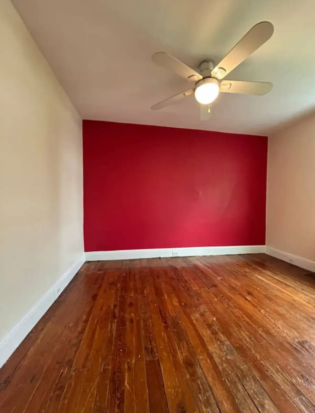 Philadelphia PA room painting – red accent wall with cream walls and white ceiling by Oasis Painting & Drywall.