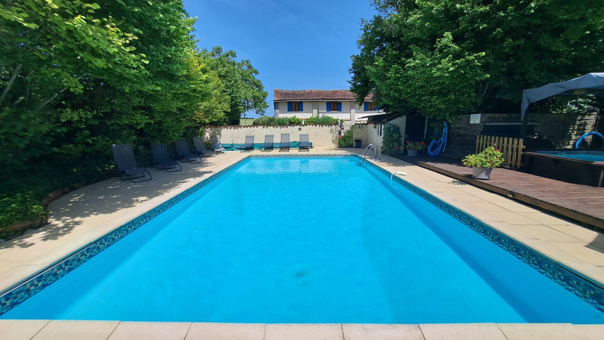 view of the Fleurie cottage from a swimming pool