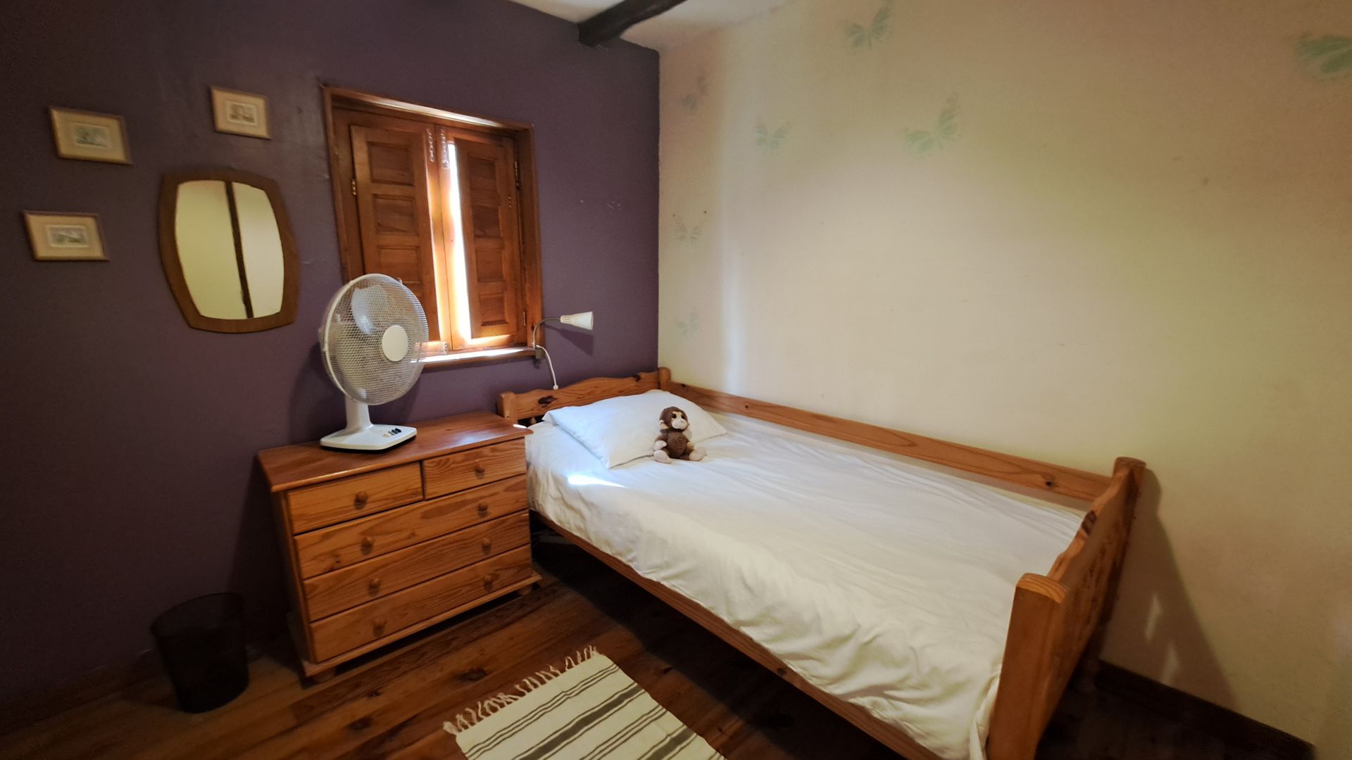 single pine bed with white bedding and pine set of draws