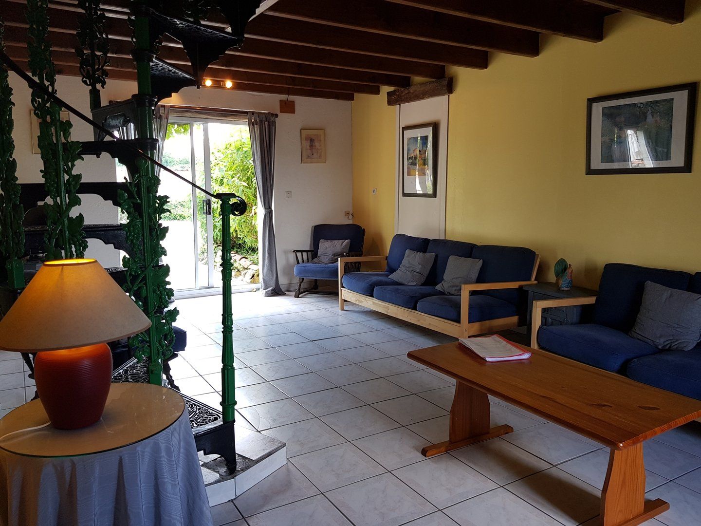 sitting room with blue ikea sofas and yellow wall
