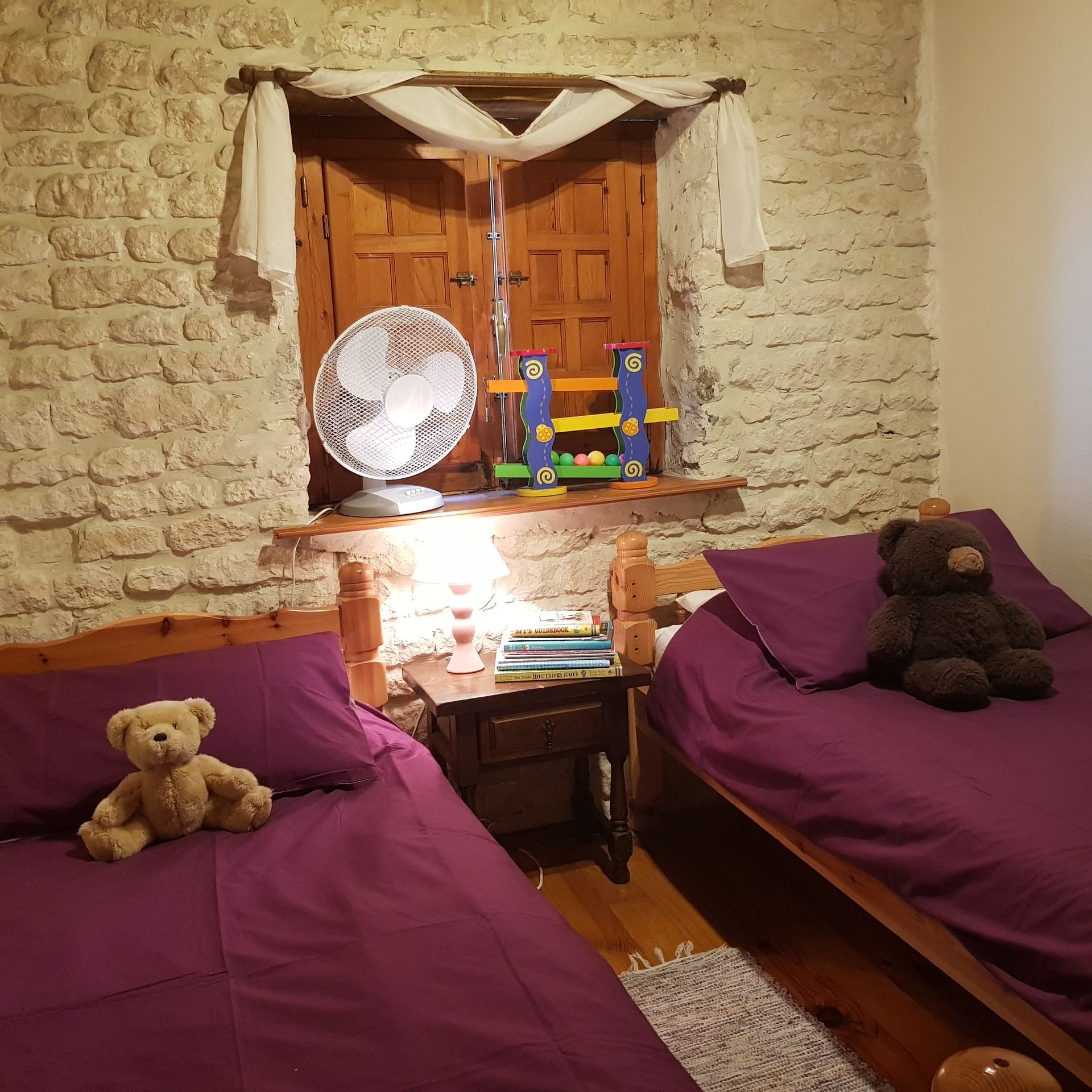 Twin childrens beds with purple bedding 