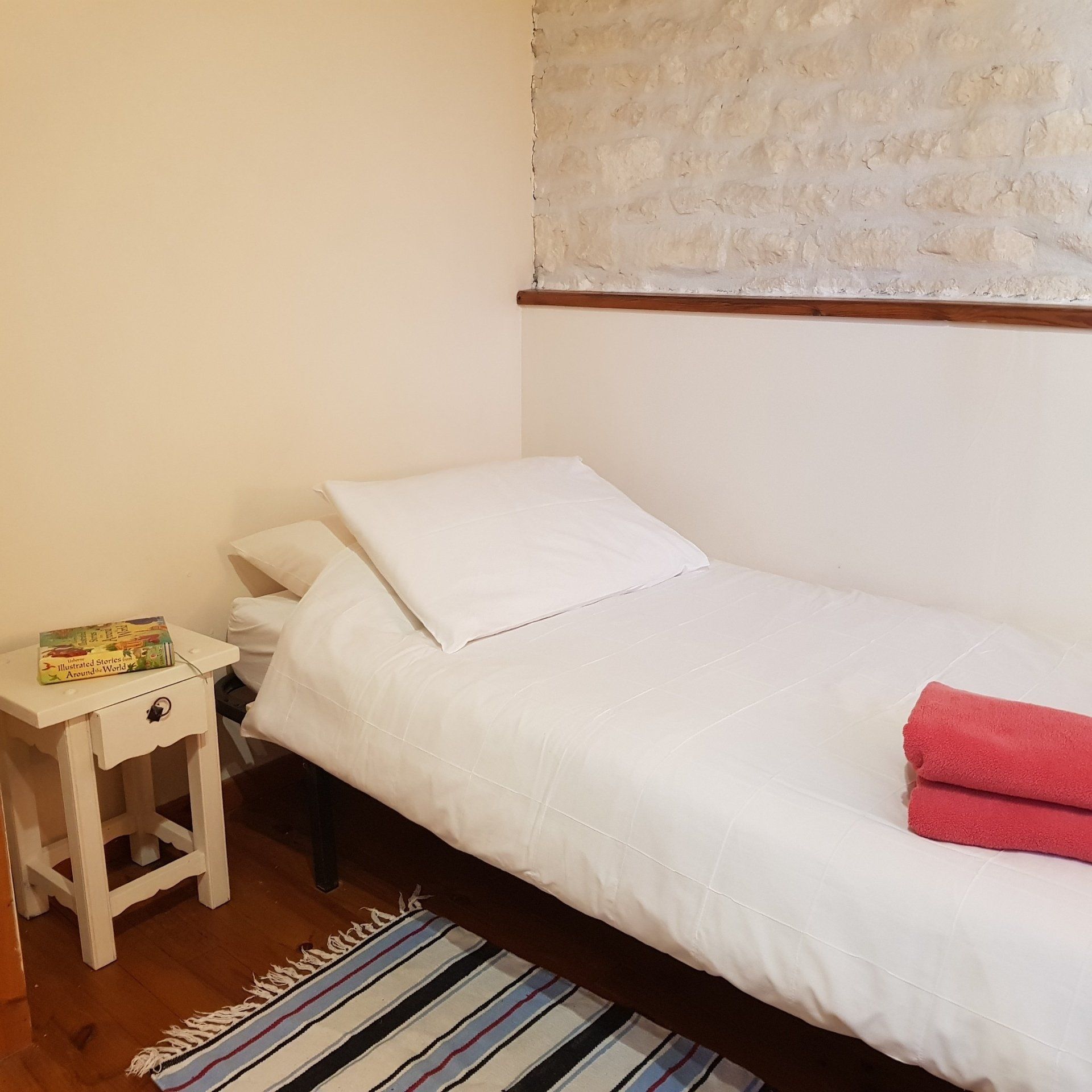 single bed with white bedding