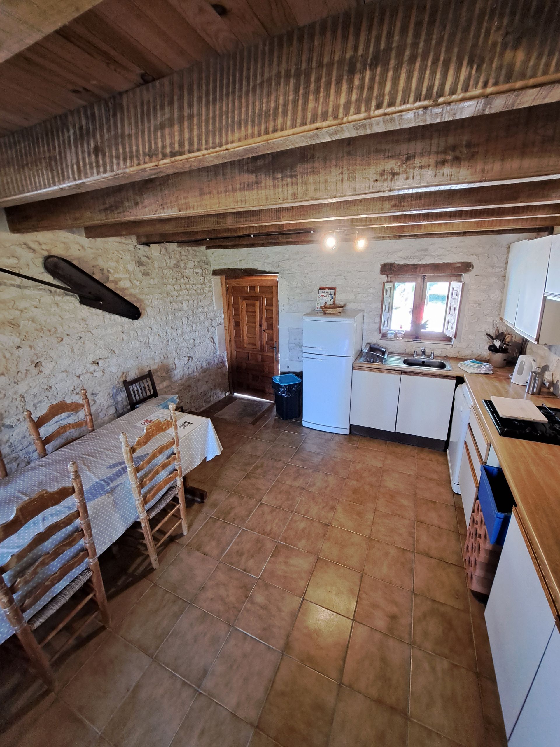 kitchen withcream cupboard doors and wood effect worktop, tiled floor