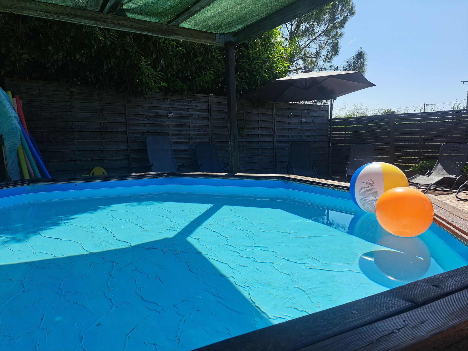 blow up balls floating on a toddler pool