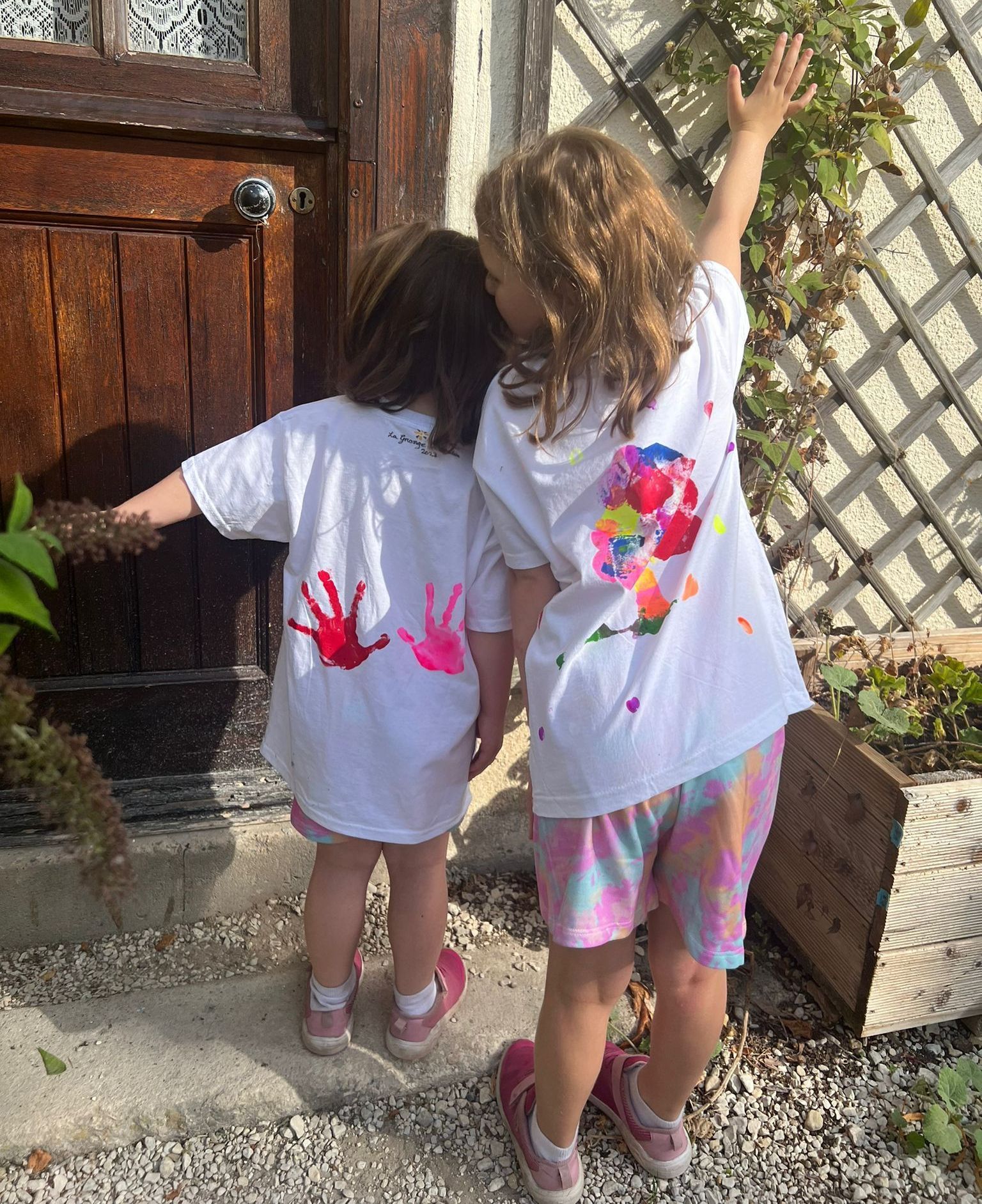 two children showing their hand painted t-shirts