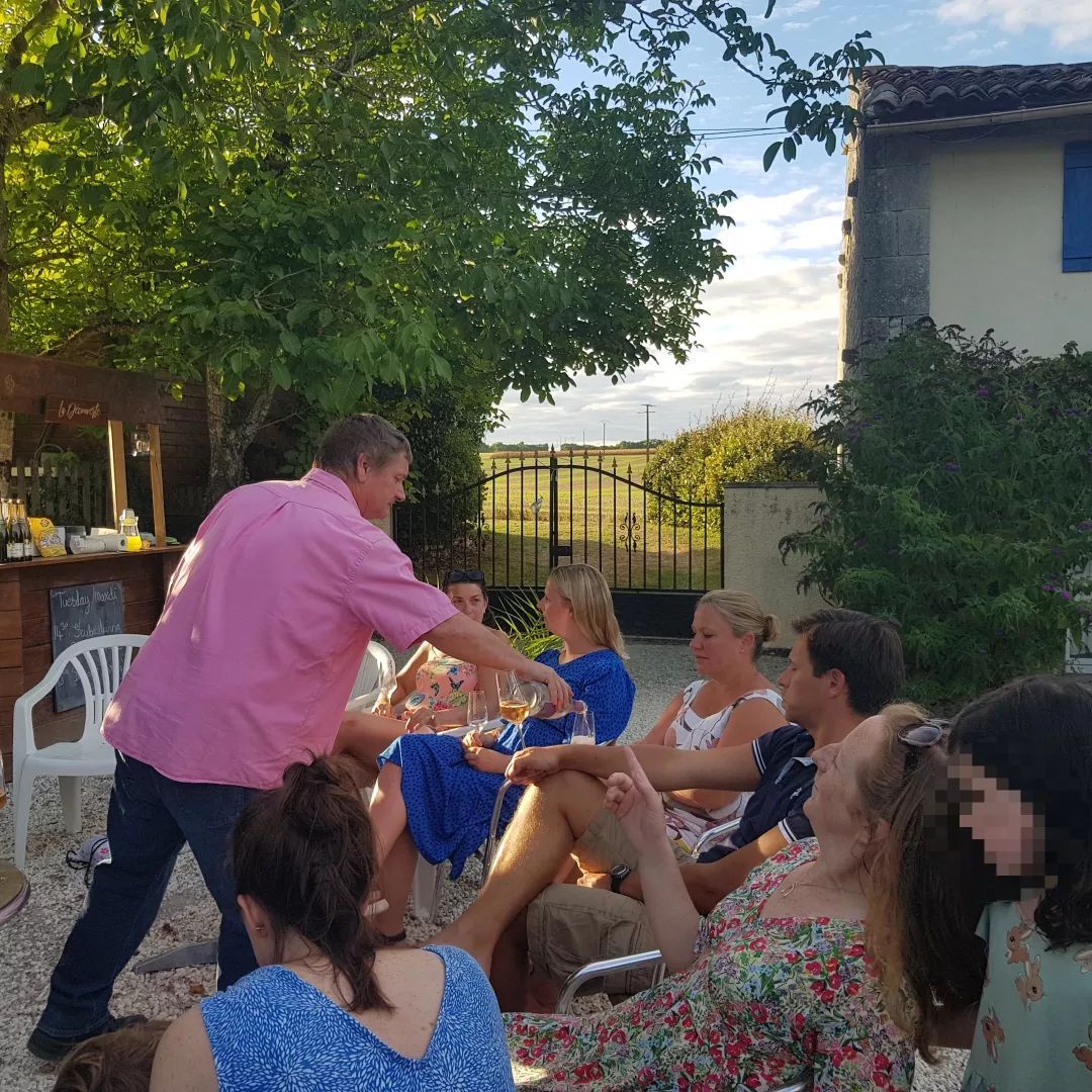 man serving wine to people