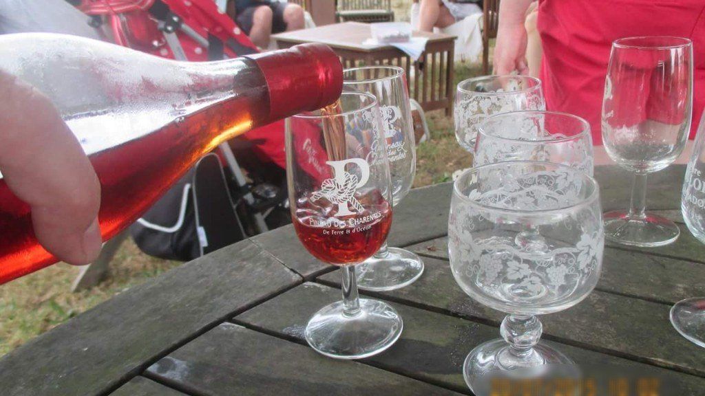 a bottle of Pineau being poured into a glass