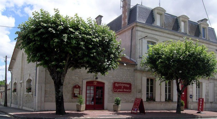 stone building with steep slate roof in France