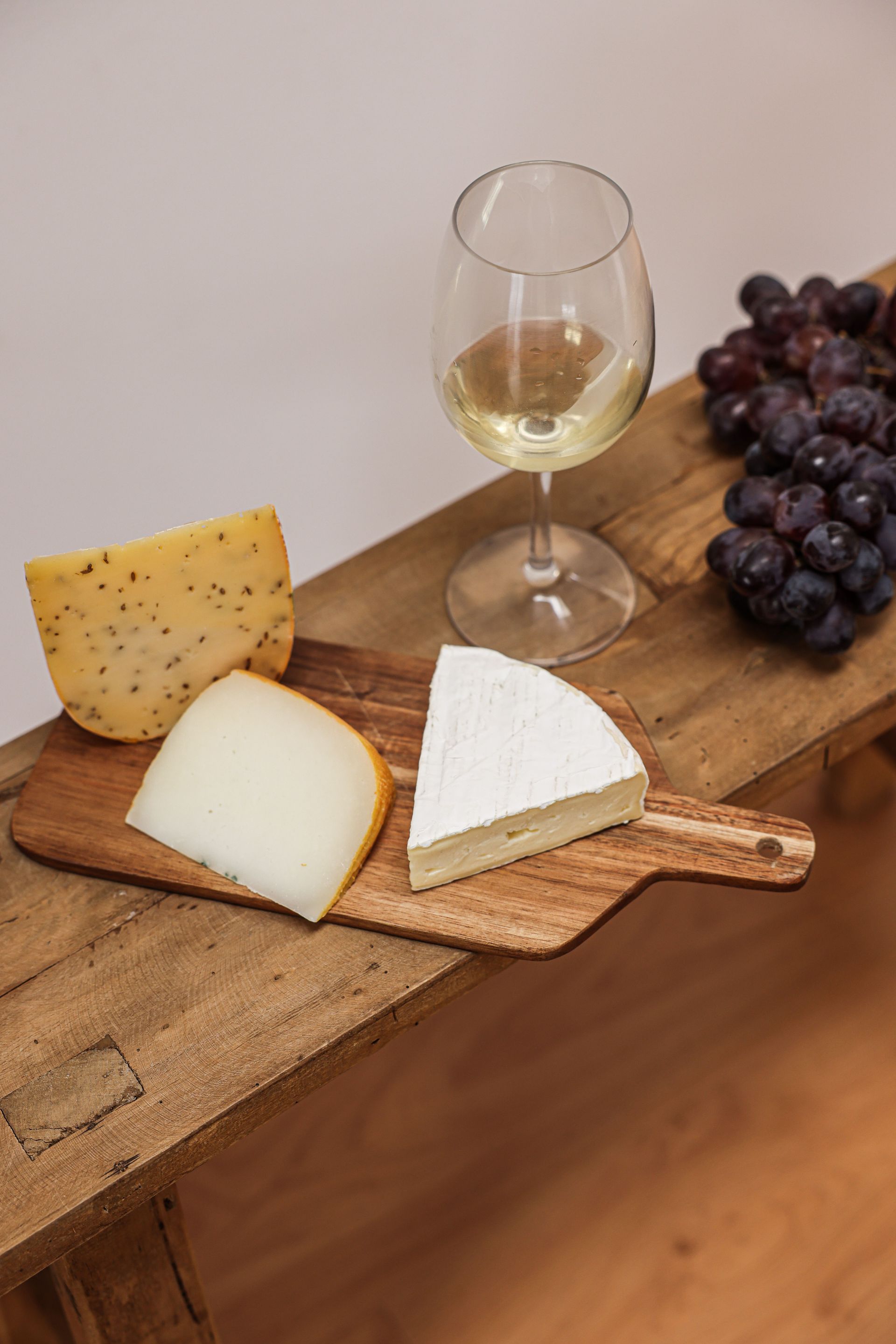 bottles of wine, popcorn and a plate of crackers and cheese