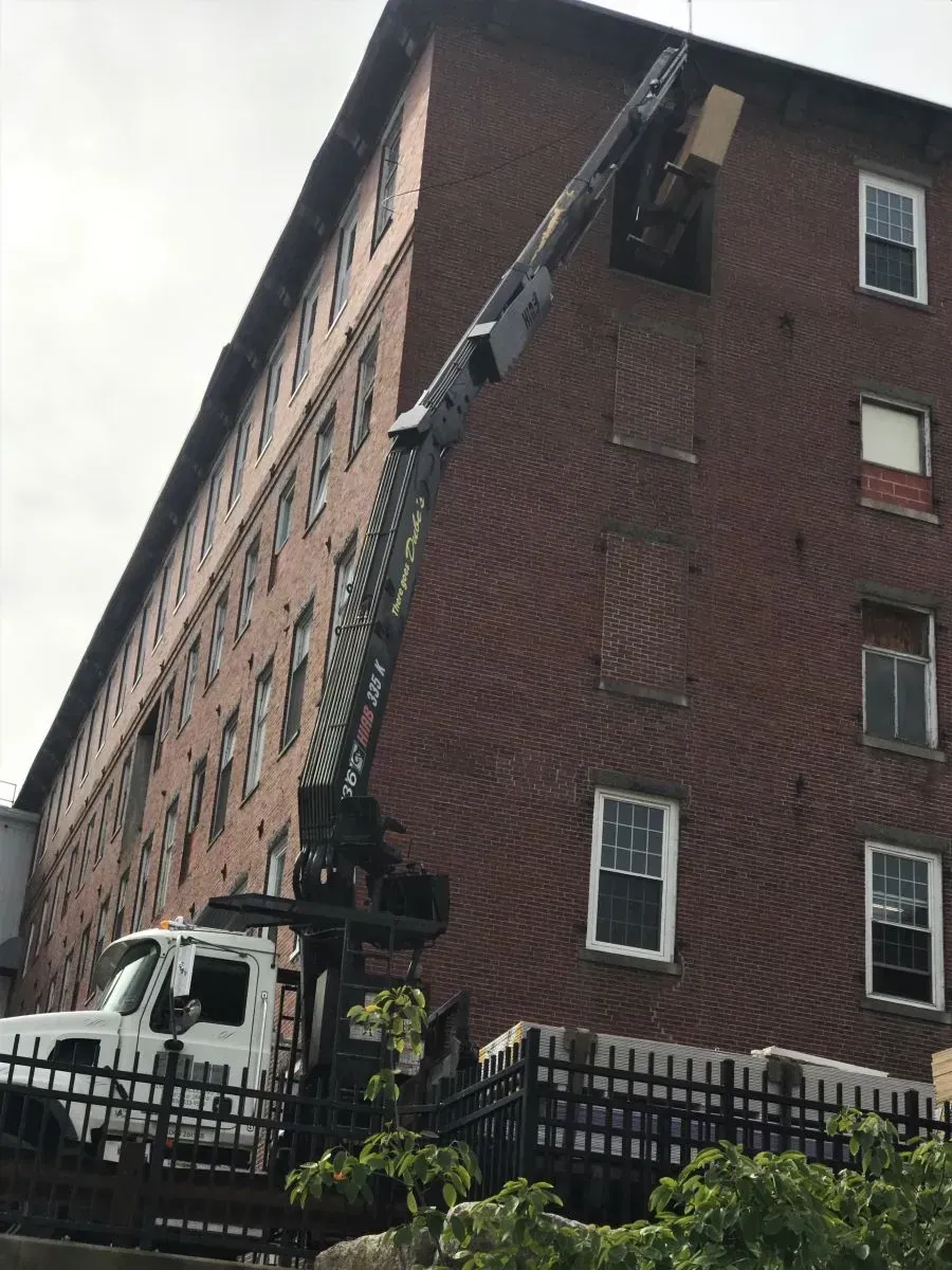 A large brick building with a white truck parked in front of it
