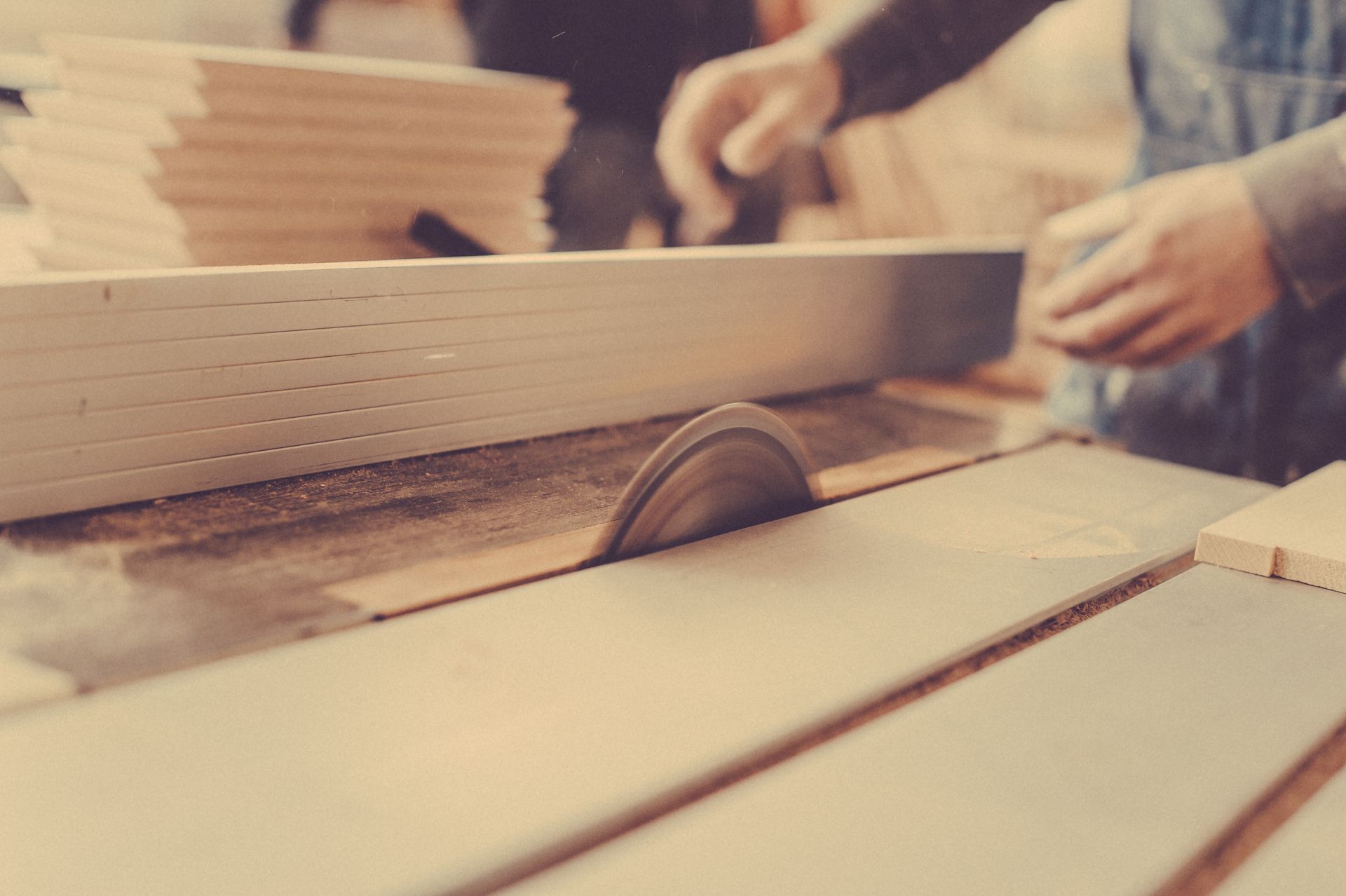 A person is using a circular saw to cut a piece of wood.