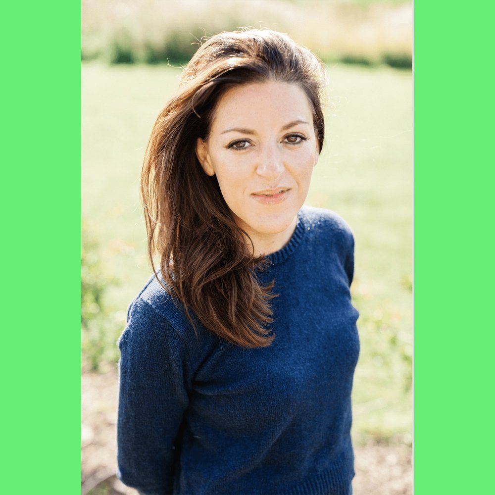 Photo of Alex - long dark hair and wearing a blue jumper.