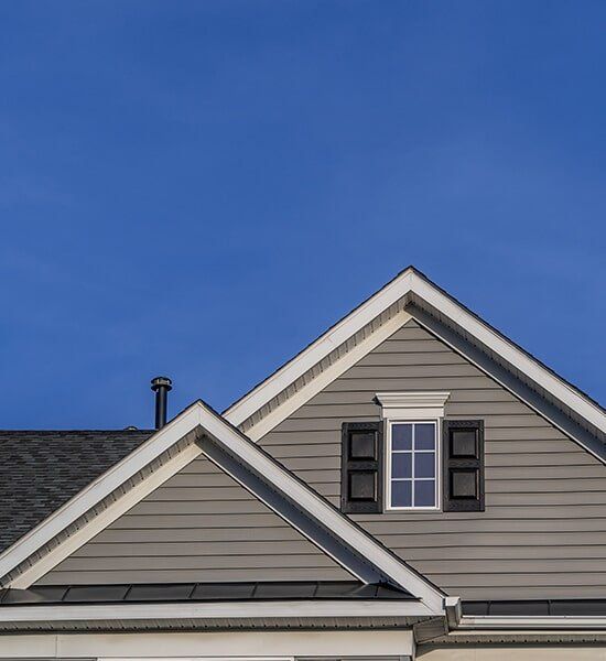 The Roof of a House With a Blue Sky in the Background — CP Roofing in Old Bar, NSW