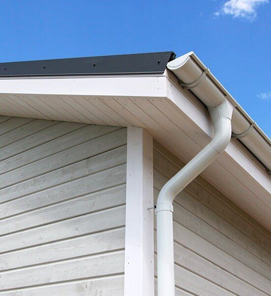 White Gutter is Attached to the Side of a House — CP Roofing in Old Bar, NSW