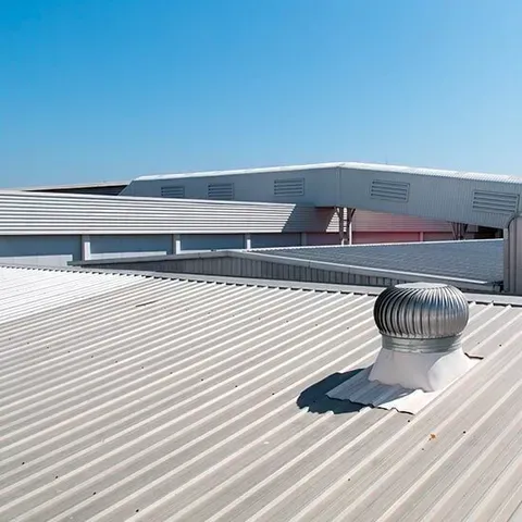 Metal Roof With a Wind Turbine on Top of It — CP Roofing in Wingham, NSW